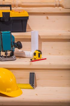 working tools on setps of wooden ladder