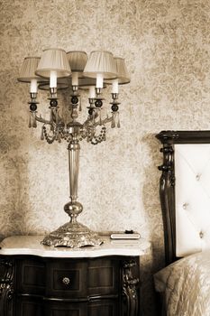 Beautiful lamp at a bed in a modern bedroom