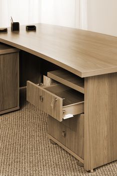 wooden table with an open box in the office