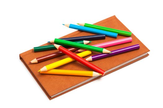 pencils and a notebook on a white background