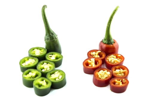 red and green hot chili pepper slices on a white background