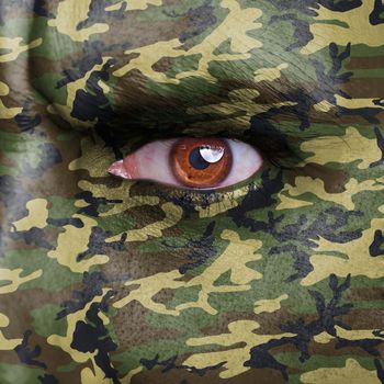 Army camouflage painted on angry soldier face