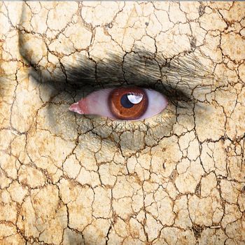 Nature concept - man face covered with cracked earth texture - symbol of dry skin