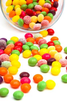 Candy in a glass jar on white background