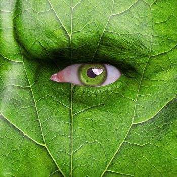 Nature concept - man face covered with leaf texture