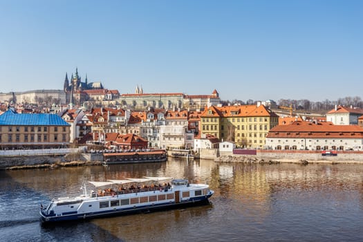 View of the castle and the Vltava River with boat, Prague, Czech Republic.