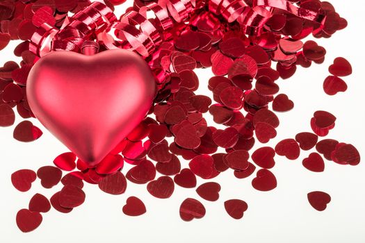 small red confetti and big hearts on white background