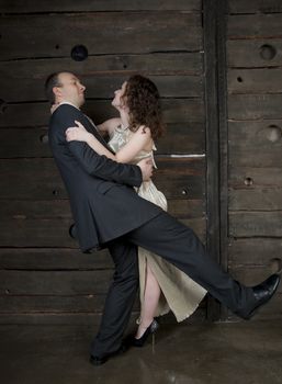 man and a woman dancing against the boards