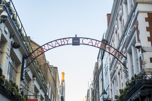 LONDON, UK - MARCH 14: Traditional Carnaby street street sign arch. The street is famous for its fashion stores. March 01, 2014 in London.