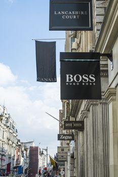 LONDON, UK - MARCH 14: Row of of banners for famous and expensive shops in New Bond Street. March 01, 2014 in London.