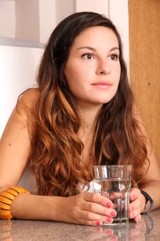 A young woman with a glass of water.