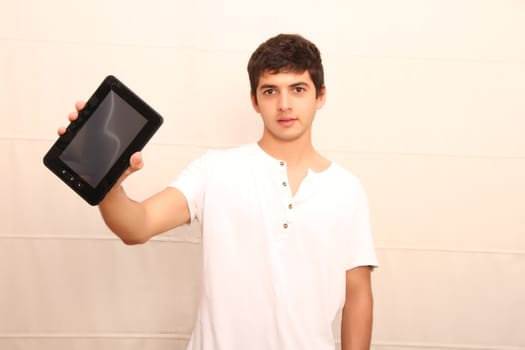 A young, latin man with a Tablet PC, tablet pc in focus
