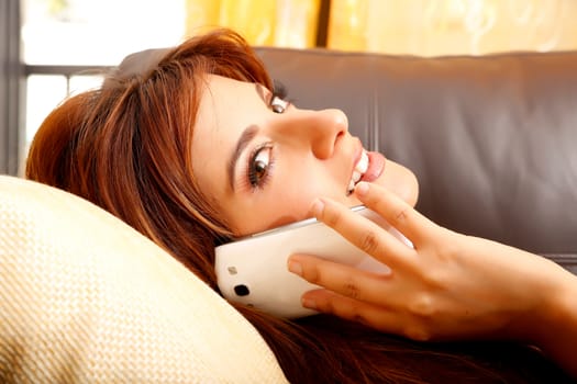 A beautiful woman talking on a smartphone.