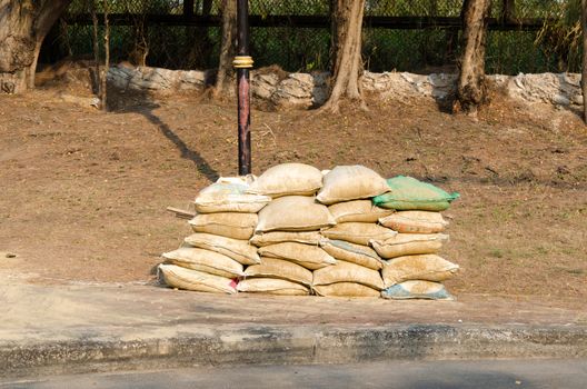 The sandbag are stacked on the floor.