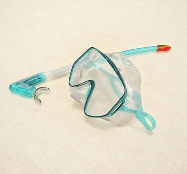 Snorkel and Mask for Diving isolated on sand