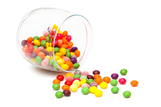 Candy in a glass jar on white background