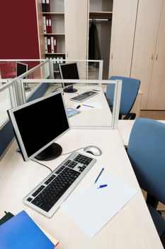 computers behind the glass in a modern office