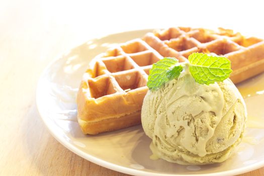 Waffle with green tea ice cream on wood