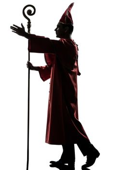 one man cardinal bishop silhouette saluting blessing in studio isolated on white background