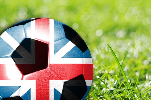 Soccer ball on grass with flag of England painted on it