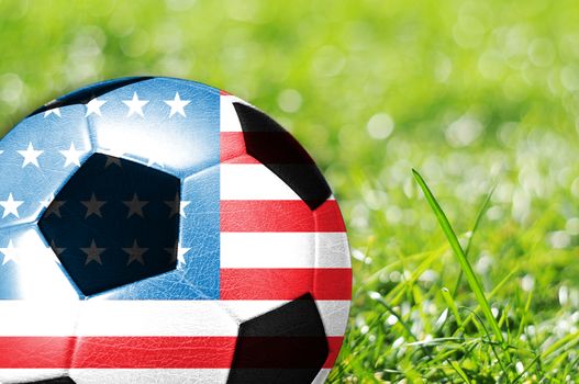 Soccer ball on grass with flag of USA painted on it