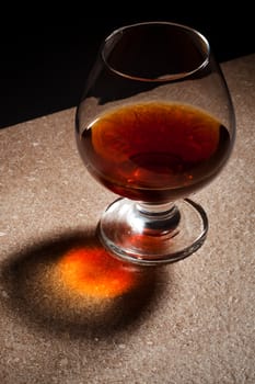 a glass of brandy on the marble table