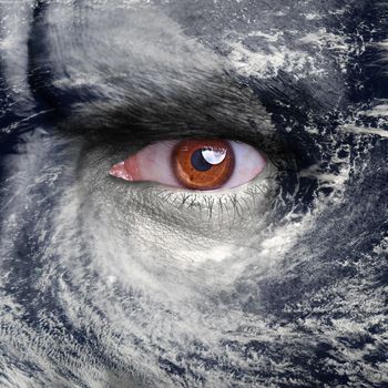 A blue eye in the middle of a tropical hurricane. Elements of this image furnished by NASA