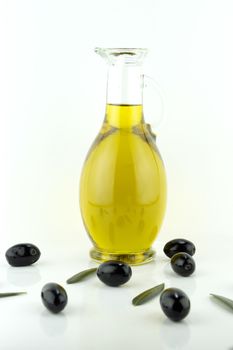 olives and a bottle of olive oil with olive leaves.