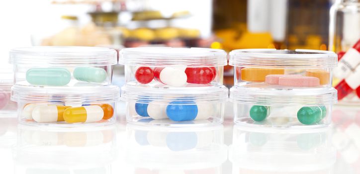 Colorful medical capsules in Petri dishes. Laboratory concept.