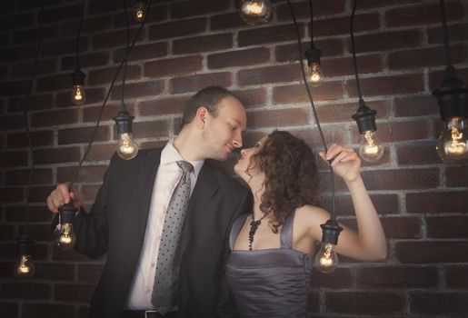 loving couple in the background of walls from a brick and light bulbs