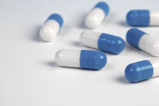 Colorful medical capsules on white background.
