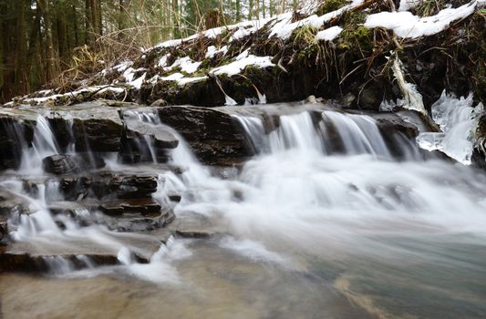 Little cascade in the forest - winter