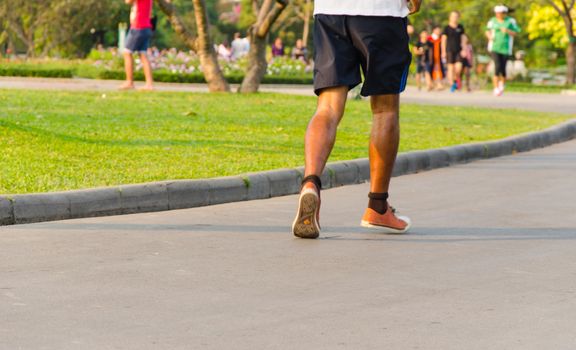 Asian men were running in the park.