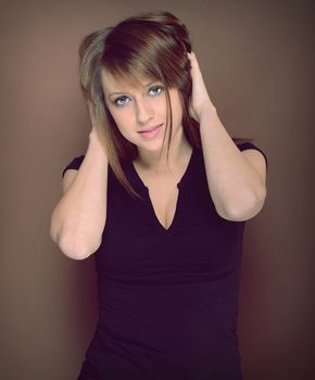 Beautiful brunette posing over brown background