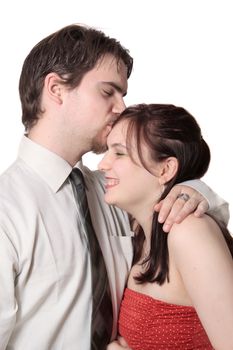 Cute young couple happy together with the man kissing the woman`s forehead on a white background