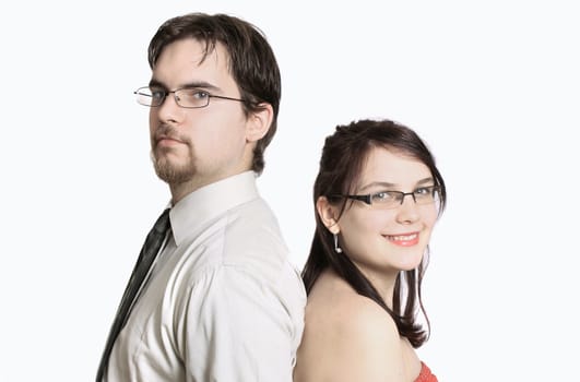 Cute young couple happy together standing back to back on a white background