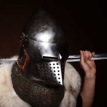Portrait of XV century knight on dark background