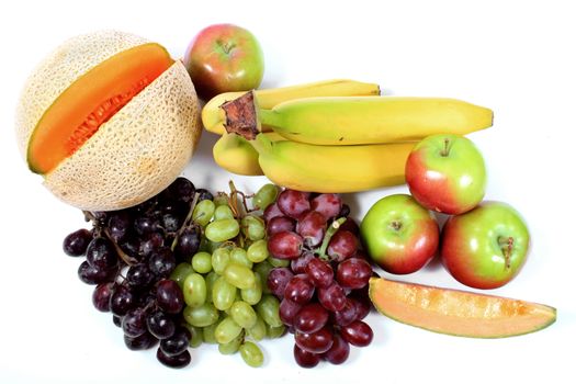 Colorful fresh fruits like grapes, cantaloupe,apples,and grapes on a white background