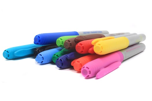 Colorful rainbow markers in blue, green, yellow and reds on a white background