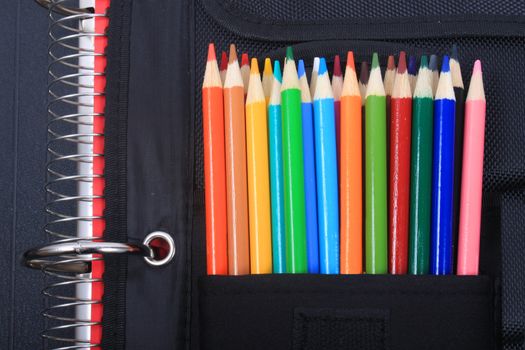 Colorful sharpened  pencil crayons for school in three ring binder pocket