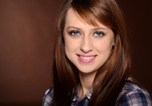 Beautiful brunette posing over brown background