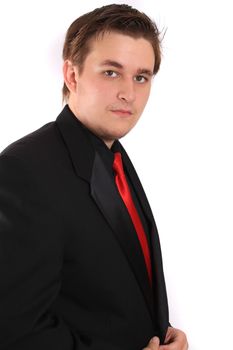 Handsome young businessman in black formal suit with red tie