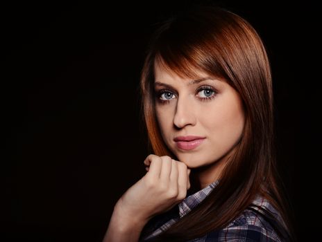 Beautiful brunette posing over dark background