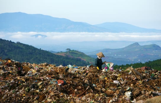 DA LAT, VIET NAM-SEPTEMBER 5: People working at landfill, thae pick up garbage to earn their live in Da Lat, VietNam on September 5, 2013