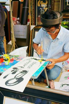 SAI GON, VIET NAM- FEBRUARY 1, 2013. People writing calligraphy at fair, this is traditional culture of Vietnamese in springtime, Sai gon, VietNam on February 1, 2013