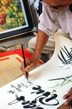 SAI GON, VIET NAM- FEBRUARY 1, 2013. People writing calligraphy at fair, this is traditional culture of Vietnamese in springtime, Sai gon, VietNam on February 1, 2013