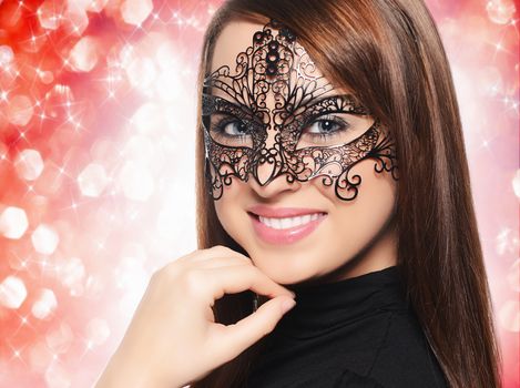 Beautiful woman in carnival mask over white background