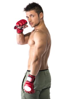Muscular shirtless young man with mixed martial arts gloves (MMA), profile view, isolated