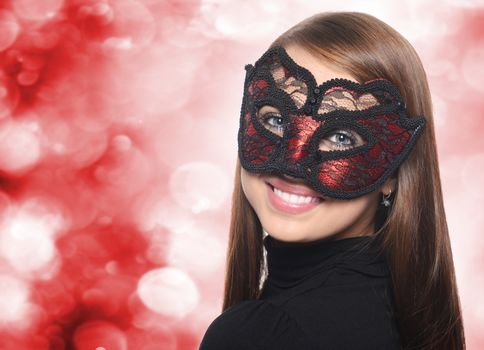 Beautiful caucasian brunette in red carnival mask over white background