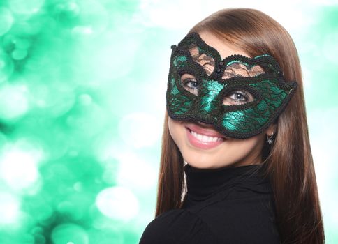 Beautiful woman in carnival mask over blue background